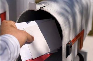 person grabbing mail from mailbox