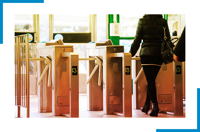 Woman walking through turnstile 