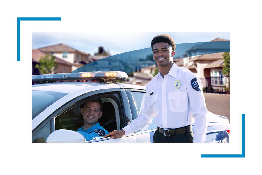 Two Allied Universal security professionals one standing and one inside the car