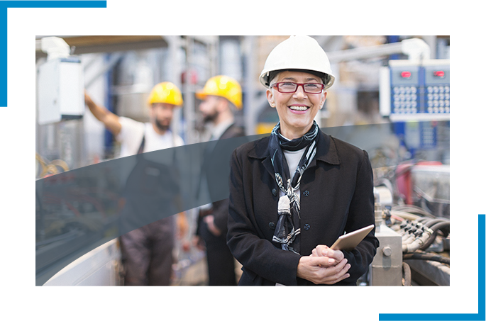 A smiling person working in an industrial facility